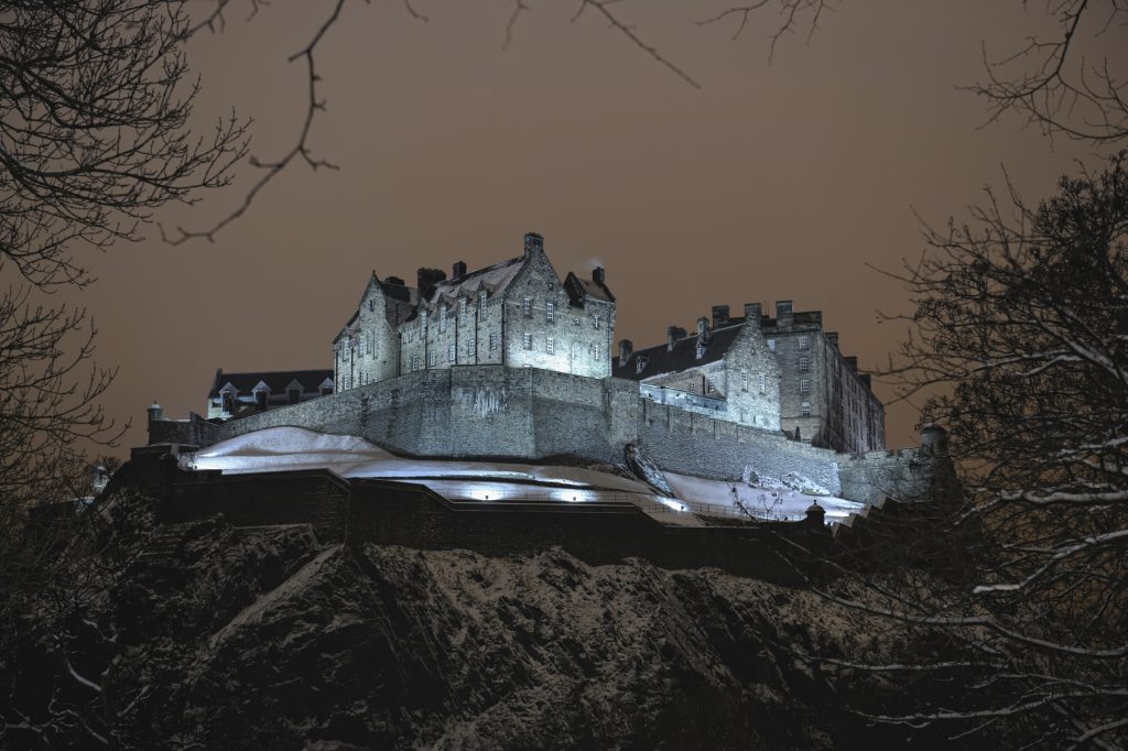 Edinburgh Castle, Scotland, UK, illuminated at night in the winter snow